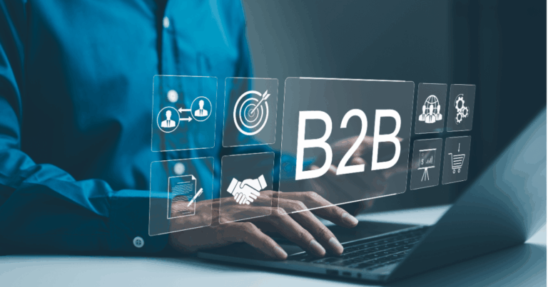 Profissional digitando em um notebook com ícones digitais de negócios e a palavra B2B na tela, representando soluções de B2B SaaS para empresas.